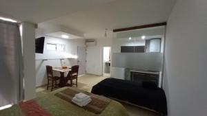 a bedroom with a bed and a table in a room at monoambiente huellas2 in La Rioja