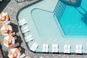 an overhead view of a swimming pool with lounge chairs at Dorsett Gold Coast in Gold Coast