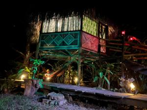 un bâtiment éclairé la nuit dans l'établissement Cabañas Bambután, à Palenque