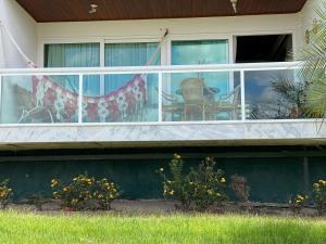 Cette maison dispose d'un balcon avec 2 chaises. dans l'établissement Flat 607 VILLA HÍPICA, à Gravatá