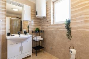 a bathroom with a sink and a mirror at Apartments Korana in Pula +85 photos