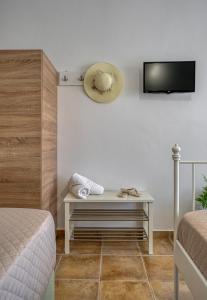 a bedroom with a table with a hat on the wall at Patrinos Studios in Alikanas