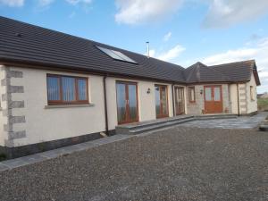 a house with a driveway in front of it at A Castle View in Keiss