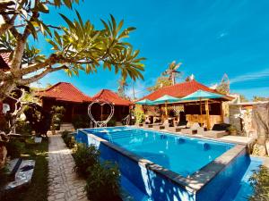 a swimming pool in front of a house at Grand Cory in Nusa Penida