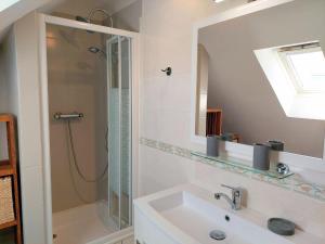 a bathroom with a shower and a sink and a mirror at Holiday Home in Plouhinec by Audierne Bay in Plouhinec +24 photos