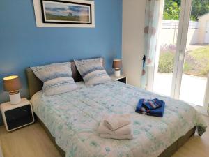 a bedroom with a bed with towels on it at Holiday Home in Plouhinec by Audierne Bay in Plouhinec