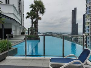 a blue swimming pool on top of a building at Wadi Iman Guesthouse @ i-City in Shah Alam