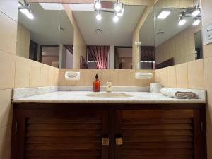 a bathroom with a sink and a large mirror at Casa Eusebio Blanco con patio parrilla y cochera en el centro de Mendoza in Mendoza +80 photos