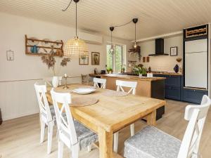 a kitchen and dining room with a wooden table and chairs at 6 person holiday home in Læsø-By Traum in Læsø