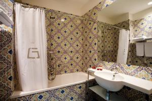 a bathroom with a sink, toilet and bathtub at Grand Hotel Due Golfi in SantʼAgata sui Due Golfi