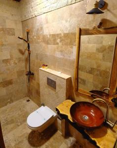 a bathroom with a wooden sink and a toilet at Larissa Cave Hotel in Nevsehir