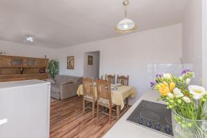 a kitchen and living room with a table and chairs at Apartment Nansy in Omiš