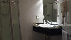 a bathroom with a sink and a mirror at Freimühle Hotel-Restaurant in Girod