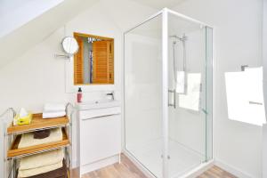 a bathroom with a shower and a sink at Louisa Chandler - Christchurch Holiday Homes in Christchurch