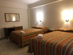 Postel nebo postele na pokoji v ubytování Hotel Lorena
