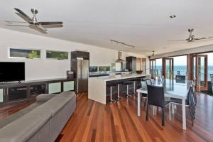 a living room with a couch and a table with chairs at Tangalooma Hilltop Haven in Tangalooma