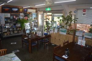 a dining room with tables and chairs in a restaurant at Oirase Guest house KEIGETSU in Yakeyama