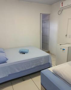 a hospital room with a bed with a towel on it at Pousada Lençóis do Delta in Tutóia