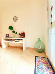 a living room with a table and a vase at B&B Siciliò in Santa Flavia