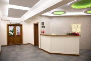 an office lobby with a reception counter and green lights at MELİTYA Hotels in Kalekoy