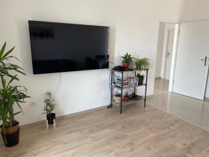 a living room with a large flat screen tv on a wall at Apartments Angela in Primošten