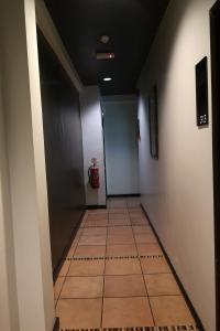 a hallway with a tile floor and a fire hydrant at OYO 89908 Hotel Kensington in Sandakan