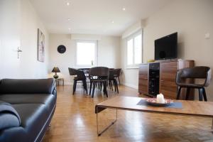 a living room with a couch and a table at La maison de Paul in Mittelwihr