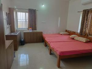 A bed or beds in a room at Sri Lakshmi Residency