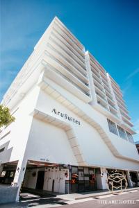 a large white building with the words australias at The Aru Hotel at Aru Suites in Kota Kinabalu