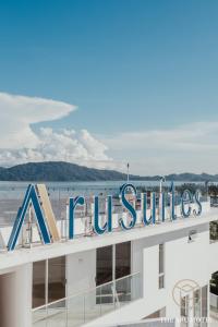 a sign on the top of a building with a beach at The Aru Hotel at Aru Suites in Kota Kinabalu