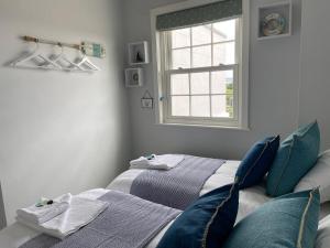 a bedroom with two beds and a window at Solent Haven, Lymington with sea views and parking in Lymington