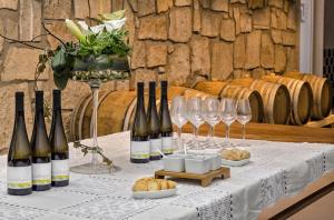 a table with wine bottles and wine glasses on it at Quinta da Teimosa in Monção