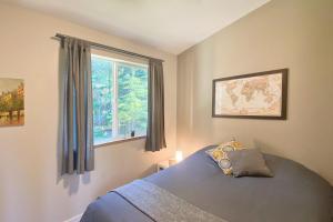 a bedroom with a bed and a window at Woodland Cabins Micro Resort in Sorrento