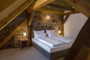 a bedroom with a bed in an attic at Hollerhöfe - Zu Gast im Dorf in Kemnath +40 photos