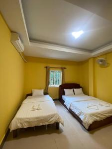 מיטה או מיטות בחדר ב-ISLANDS BOUTIQUE Koh Rong