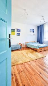 sypialnia z łóżkiem i drewnianą podłogą w obiekcie Rybnicka 10 w mieście Katowice