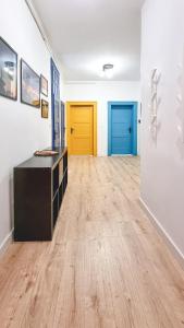 a hallway with two doors in a room with wooden floors at Rybnicka 10 in Katowice
