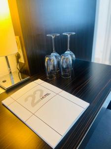 a table with two wine glasses on top of it at Hotel 22 in Dessau