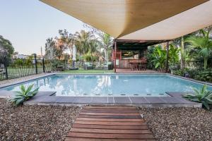 a swimming pool in a yard with a house at Agnes Water Stays over18's in Agnes Water