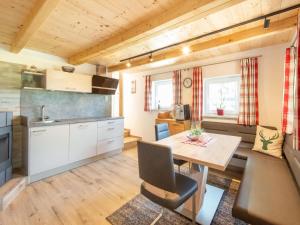 a kitchen and dining room in a tiny house at Alpine Holiday Home in Bramberg am Wildkogel with Garden in Bramberg am Wildkogel