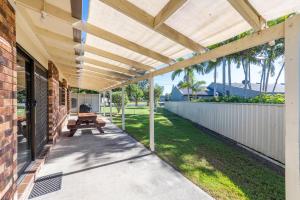 a patio with a wooden pergola and a picnic table at Crowes Nest in Iluka