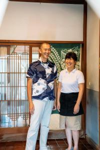 a man and a woman standing in front of a window at Tabinoya - Vacation STAY 69884v in Kakegawa