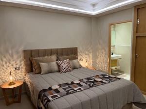 Luxury Apartment 105sqm Terrace Seafront WIFI Unlimited في أغادير: غرفة نوم بسرير كبير في غرفة