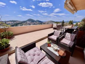 a balcony with chairs and a table with a view at Apartment Lana in Dubrovnik