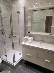 a bathroom with a shower and a sink and a mirror at Alte Teestube Alte Teestube 57 in Norderney +7 photos
