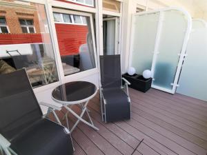 a room with two chairs and a mirror at Alte Teestube Alte Teestube 57 in Norderney