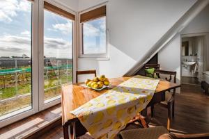 a dining room with a table with a bowl of fruit on it at Pension Hauschildt in Jork