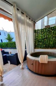 a hot tub in a room with a balcony at La Dolce Vita - Casa Vacanza Tortolì-Arbatax in Tortolì