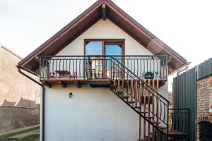 a house with a balcony with a cow sitting on the porch at Casa Sara in Turda