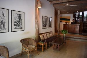 a living room with a table and chairs at Sala Prabang Hotel in Luang Prabang